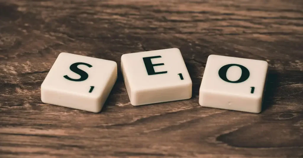 Three scrabble tiles spelling out the acronym SEO